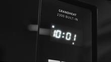 Micro-ondes numérique encastrable GrandHeat 2300 Built-In Black. 800 W de puissance, 23 litres de capacité, gril, 5 niveaux, 8 fonctions préconfigurées et minuterie.