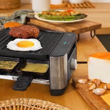 Appareil à raclette Cheese&Grill 16000 Inox Noir pour 8 personnes avec un grill de 1400 W. Avec une structure design avec des finitions en acier inoxydable, un thermostat réglable et une plaque de cuisson antiadhésive en fonte d'aluminium avec une surface mixte grill-fer. Comprend 8 petites poêles antiadhésives et 8 spatules en bois.