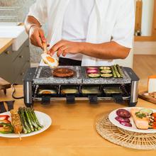 Cheese&Grill 16000 Inox Allstone Raclette-Gerät für 8 Personen mit einem 1400-W-Grill. Mit einer Designerstruktur mit Edelstahloberflächen, einstellbarem Thermostat und Natursteinplatte mit flacher Eisenoberfläche. Enthält 8 kleine antihaftbeschichtete Pfannen und 8 Holzspatel.