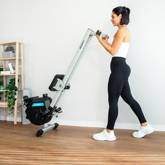 Cecotec DrumFit Rower 5500 Regatta plegada y transportándose con ruedas