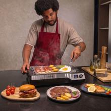Teppanyaki Steel Plancha eléctrica tipo teppanyaki con placa de acero inoxidable desmontable, temperatura regulable de 100 a 250 °C y accesorios incluidos.