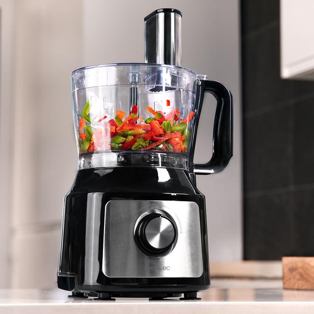 Robot culinaire Comino 1000 Spatula, 1000 W, 2 vitesses, fonction pulse, bol de 2 L. 3 disques de découpe : lame à hacher, lame à pétrir, disque à jus et disque à crémer. Corps en plastique et acier inoxydable.